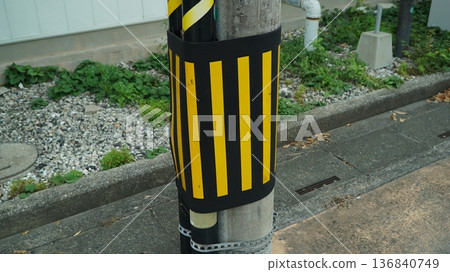 Black and Yellow Striped Warning Cover on Street Utility Pole Black and Yellow Striped Warning Cover on Street Utility Pole 136840749