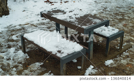 Tables and benches in a park covered in snow Tables and benches in a park covered in snow 136840814