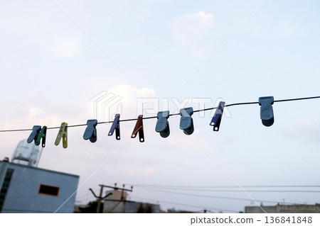 Colorful Clothespins Hanging on Laundry Line Outdoors Colorful Clothespins Hanging on Laundry Line Outdoors 136841848