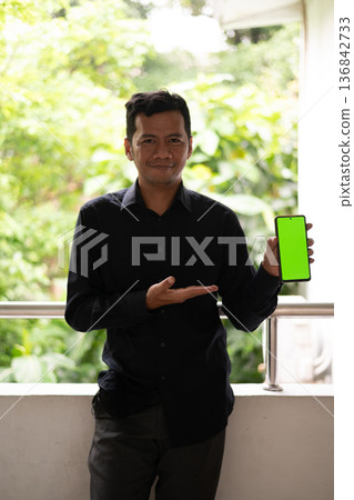 asian businessman standing in a lobby of a hotel 136842733