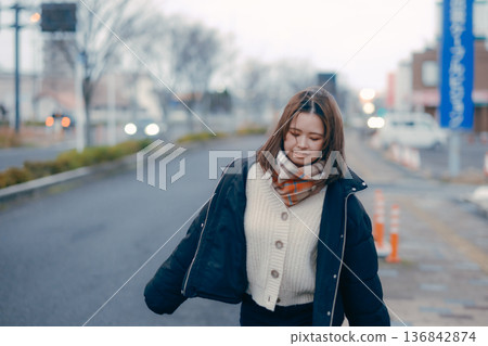 Young woman walking in the evening city Young woman walking in the evening city 136842874