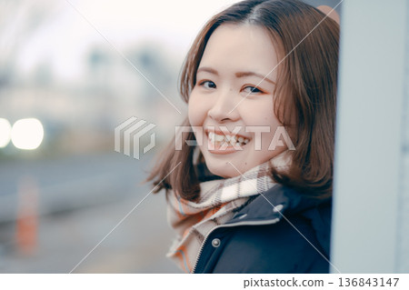 Pensive young woman in the evening city 136843147