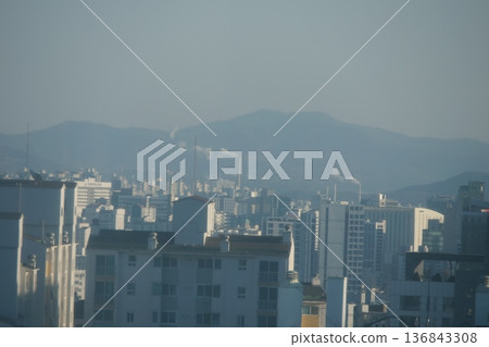 Hazy Korean City Skyline with Mountains and High Rise Apartments Hazy Korean City Skyline with Mountains and High Rise Apartments 136843308