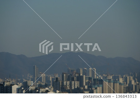 Hazy Korean City Skyline with Mountains and High Rise Apartments Hazy Korean City Skyline with Mountains and High Rise Apartments 136843313