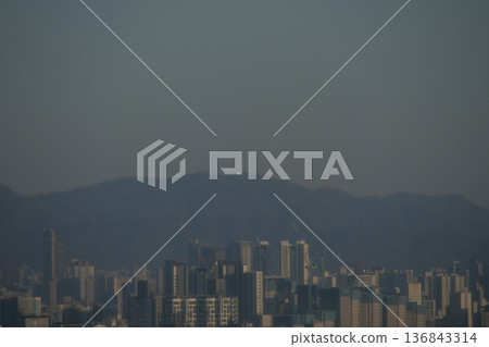 Hazy Korean City Skyline with Mountains and High Rise Apartments 136843314