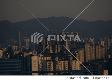 Hazy Korean City Skyline with Mountains and High Rise Apartments 136843315