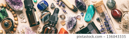 Assorted Crystals, Essential Oils, and Dried Herbs on Beige Background Assorted Crystals, Essential Oils, and Dried Herbs on Beige Background 136843335