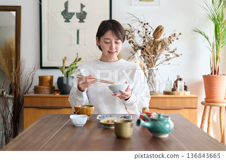 A woman eating breakfast A woman eating breakfast 136843665
