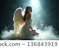 Young beautiful woman in white dress with angel wings on black background 136843919