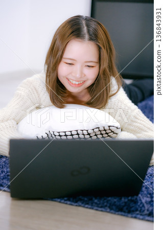 A Japanese woman in her twenties looking at a laptop A Japanese woman in her twenties looking at a laptop 136843931
