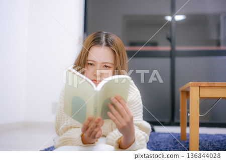 A Japanese woman in her twenties reading at home A Japanese woman in her twenties reading at home 136844028