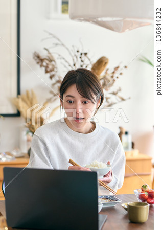 Busy woman eating breakfast 136844232