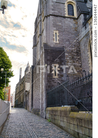 A historic alleyway in Dublin, Ireland, showcasing a stone building and cobblestone street. A historic alleyway in Dublin, Ireland, showcasing a stone building and cobblestone street. 136844447
