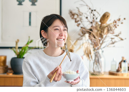 A woman eating Shishamo for breakfast 136844603