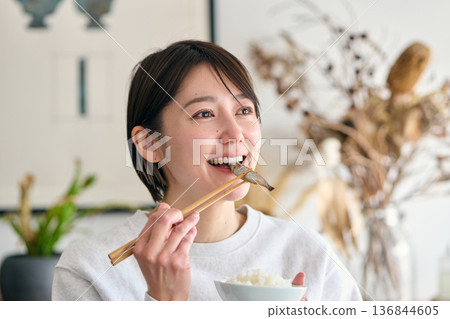 一位女士早餐吃柳葉魚 一位女士早餐吃柳葉魚 136844605