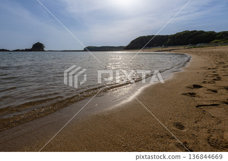 Shining waves and sandy beach 136844669