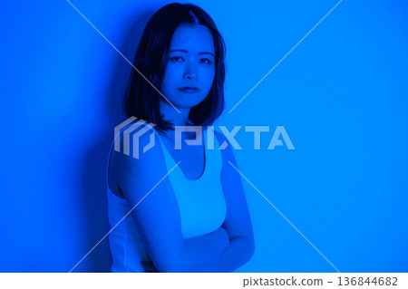A Japanese woman in her 20s surrounded by blue light A Japanese woman in her 20s surrounded by blue light 136844682