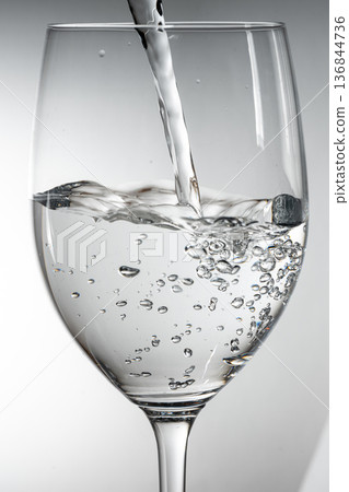 pour water into a cup pour water into a cup 136844736