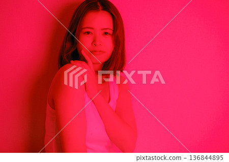 A Japanese woman in her twenties surrounded by red light A Japanese woman in her twenties surrounded by red light 136844895