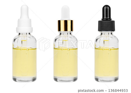 Glass bottle with cuticle oil and facial serum isolated on white background Glass bottle with cuticle oil and facial serum isolated on white background 136844933