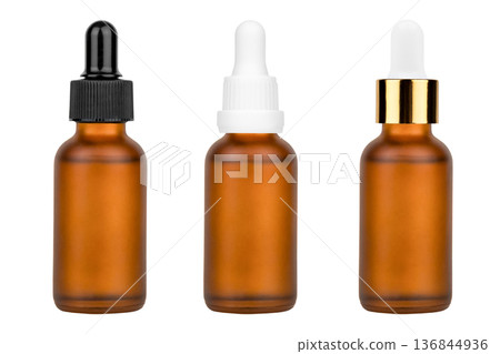 Glass bottle with cuticle oil and facial serum isolated on white background Glass bottle with cuticle oil and facial serum isolated on white background 136844936