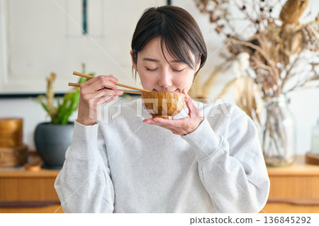 A woman drinking miso soup A woman drinking miso soup 136845292