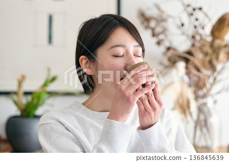 Woman drinking tea 136845639