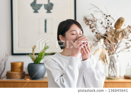 Woman drinking tea 136845641