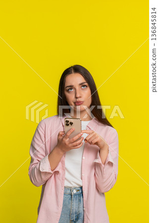Woman scrolling social media smartphone rolling eyes irritated annoyed bored negative tired reaction Woman scrolling social media smartphone rolling eyes irritated annoyed bored negative tired reaction 136845814