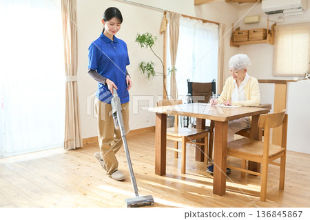 Asian caregiver cleaning during home visit care 136845867