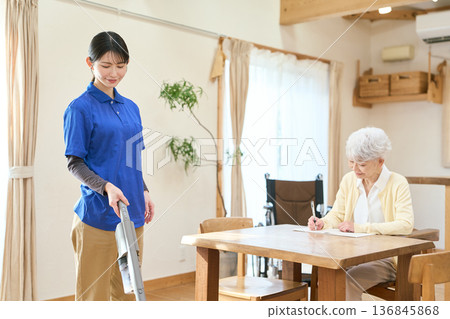 Asian caregiver cleaning during home visit care 136845868
