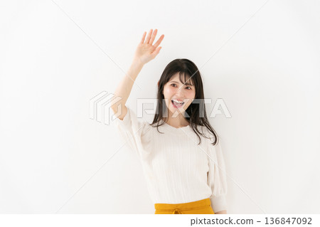 Middle-aged woman portrait waving 136847092
