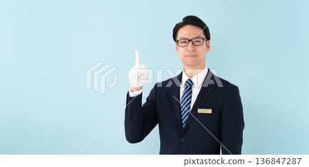 Businessman with white gloves pointing 136847287