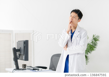 Medical white coat man thinking 136847591