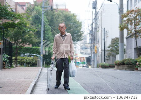 一位老人購物後返回。 136847712