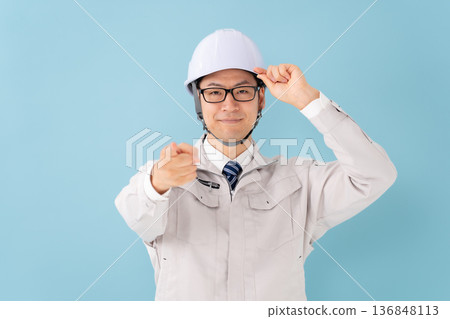 Male in work clothes pointing Male in work clothes pointing 136848113