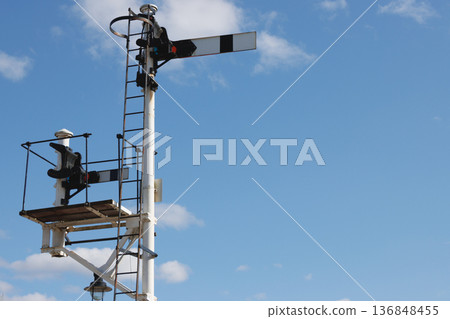 Pair of old-fashioned railway semaphore signals and blue sky background Pair of old-fashioned railway semaphore signals and blue sky background 136848455