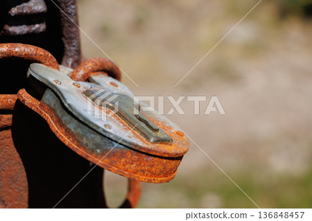Close-up of rusty metal padlock on gatepost Close-up of rusty metal padlock on gatepost 136848457