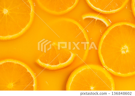 Orange slices swimming in fresh orange juice, horizontal macro. Orange slices swimming in fresh orange juice, horizontal macro. 136848602