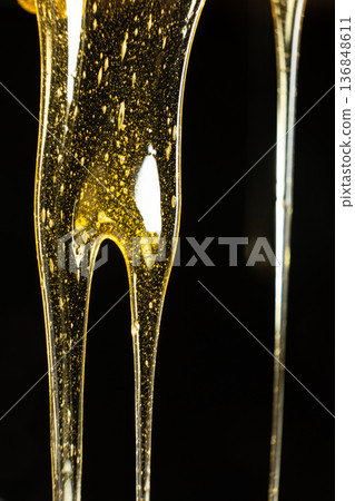 Macro Texture Of Liquid Fresh Honey On Black Background. Macro Texture Of Liquid Fresh Honey On Black Background. 136848611