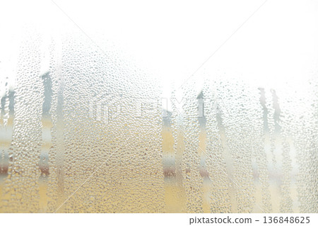 Wet window glass surface with heavy moisture and misted texture. 136848625