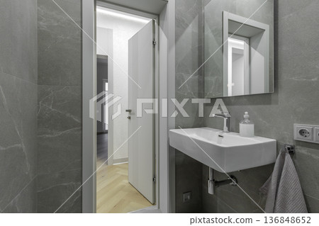 Modern Bathroom with Grey Stone Tile and White Basin 136848652