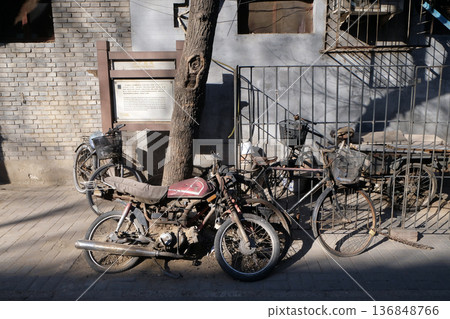 Street Scene with Bicycle and Motorbike in front of a courtyard door in Beijing hutong Street Scene with Bicycle and Motorbike in front of a courtyard door in Beijing hutong 136848766