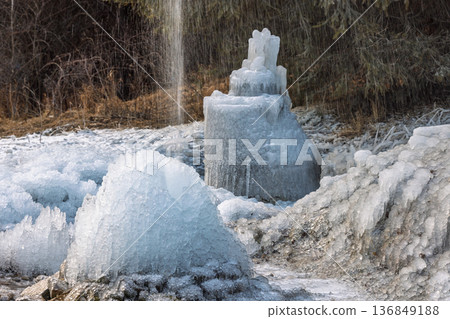 Frozen water structures dominate the landscape, showcasing nature's artistry with intricate icicles. A winter wonderland is created by cold temperatures, shaping ice formations. Frozen water structures dominate the landscape, showcasing nature's artistry with intricate icicles. A winter wonderland is created by cold temperatures, shaping ice formations. 136849188