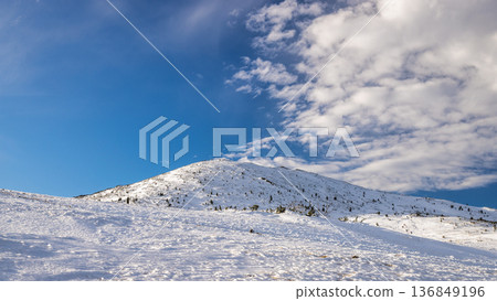 Snowy mountain peak under a vibrant blue sky. The Mala Fatra national park in northwest of Slovakia, Europe. 136849196