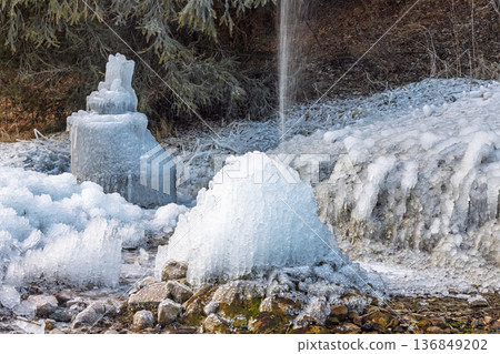 Icy sculptures formed by frozen water create a surreal, arctic landscape. The contrast of water and ice showcases the beauty of the natural elements at play in winter. Icy sculptures formed by frozen water create a surreal, arctic landscape. The contrast of water and ice showcases the beauty of the natural elements at play in winter. 136849202