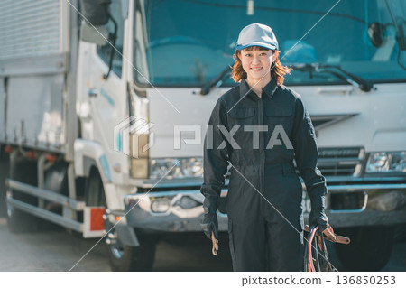Female auto mechanic and large truck 136850253