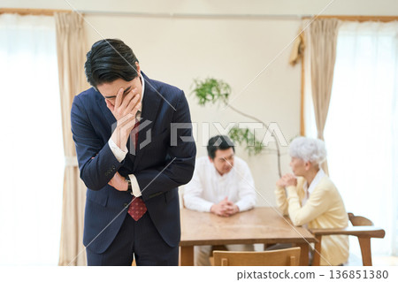 Asian businessman worried about the burden of caregiving 136851380