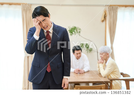 Asian businessman worried about the burden of caregiving 136851382