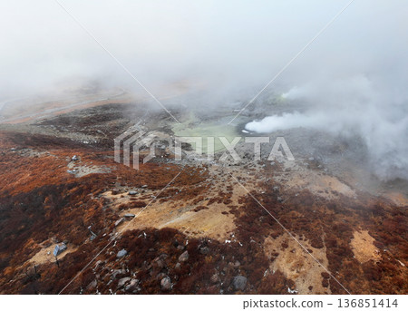 Aerial view of Mount Io spewing steam through the mist Aerial view of Mount Io spewing steam through the mist 136851414